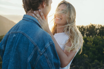 Romantic blond woman touching gently on boyfriend's neck