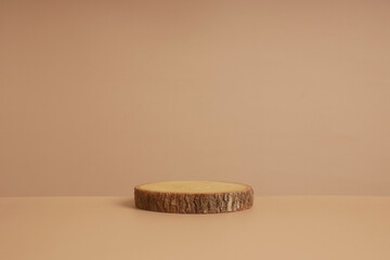 modern product display on neutral beige background. Wood slice podium and green leaves. Concept scene stage showcase for new product, promotion sale, banner, presentation, cosmetic