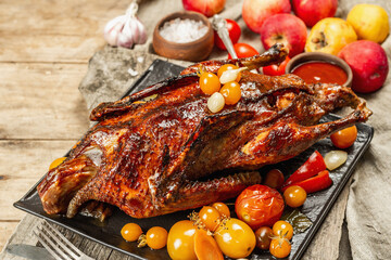 Whole roast duck stuffed with apples. Poultry served with pickled vegetables