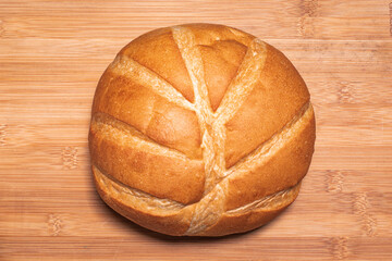 freshly baked bread on wooden tops background, top view