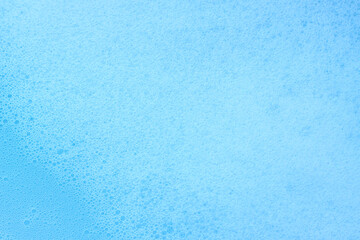 Soap foam texture on blue background, Cleansing foam bubbles
