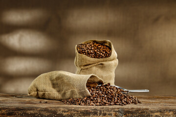 Fresj coffee beans in sack and wall with shadows. 
