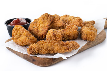 Crispy Kentucky fried chicken on cutting board isolated on white background	