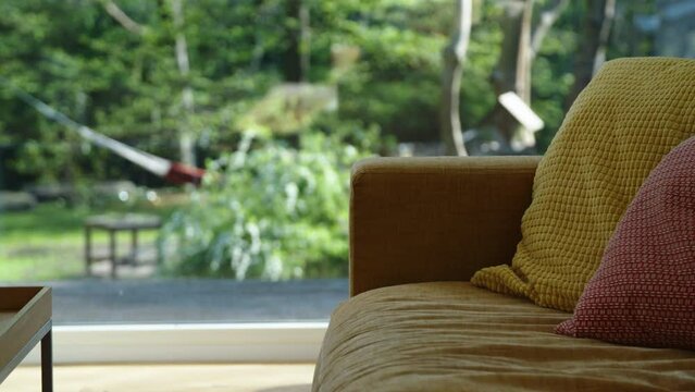 Sofa with cushions and outdoor background. Shallow depth of field.