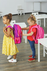 pupils girlfriends with backpacks on their backs came to the classroom
