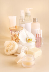 Fototapeta na wymiar Natural cosmetic jars and skin care accesories with white orchid flower on light yellow copy space