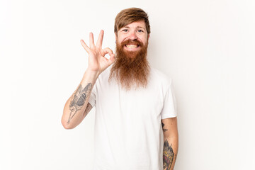 Young caucasian red-haired man isolated on white background cheerful and confident showing ok gesture.