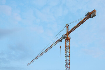 Construction tower crane against the blue sky.