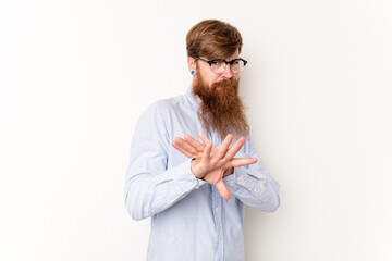 Young caucasian red-haired man isolated on white background doing a denial gesture
