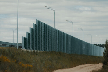 A road fence. The long protection fence along the highway