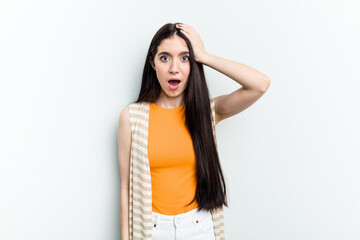 Young caucasian woman isolated on white background being shocked, she has remembered important meeting.