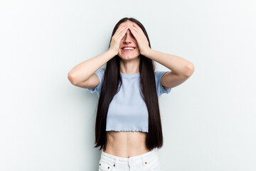Fototapeta premium Young caucasian woman isolated on white background laughs joyfully keeping hands on head. Happiness concept.