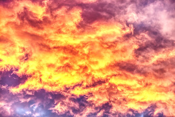 Swirling evening clouds illuminated by the setting sun