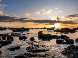 Sunset at Mauritius Pointe aux Biches beach with boats in foreground