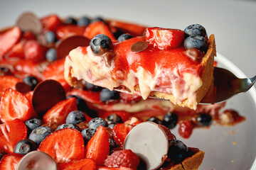 Caramel tart with summer berries. Close-up. Selective focus