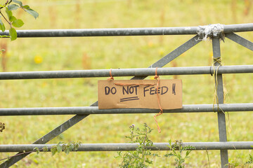 A hand-painted sign that says Please do Not feed