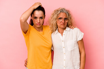 Caucasian mom and daughter isolated on pink background being shocked, she has remembered important meeting.