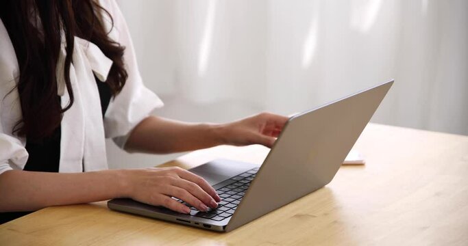 A Japanese woman checking smartphone in the home office faceless composition