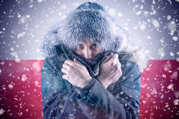 Isolate. Cold weather. Bask. A man in a fur hat and scarf warms his hands with his mouth. It's...