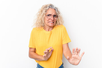 Middle age caucasian woman isolated on white background rejecting someone showing a gesture of disgust.