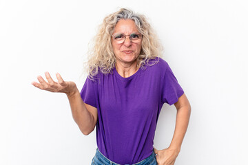 Middle age caucasian woman isolated on white background doubting and shrugging shoulders in...