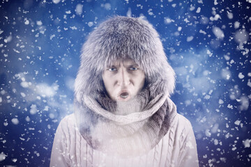 Isolate. Cold weather. Bask. A man in a fur hat and scarf warms his hands with his mouth. It's...