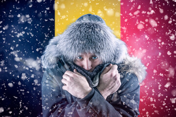 Isolate. Cold weather. Bask. A man in a fur hat and scarf warms his hands with his mouth. It's...