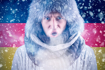 Isolate. Cold weather. Bask. A man in a fur hat and scarf warms his hands with his mouth. It's...