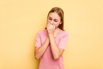 Young caucasian girl isolated on yellow background suffers pain in throat due a virus or infection.