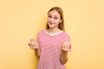 Young caucasian girl isolated on yellow background pointing with finger at you as if inviting come closer.