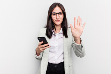 Young business caucasian woman holding mobile phone isolated on white background smiling cheerful...