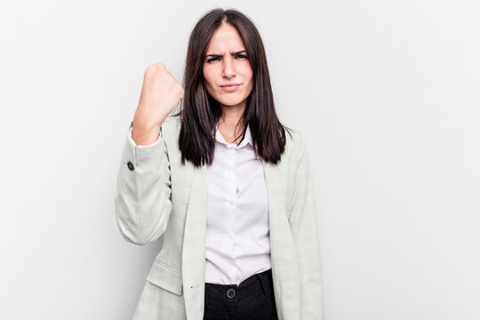 Young business caucasian woman isolated on white background showing fist to camera, aggressive facial expression.