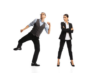 Portrait of man, office manager cheerfully dancing near woman, employee isolated over white background. Successful job