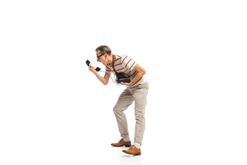 Portrait of stylish businessman in retro clothes shouting on vintage phone isolated over white background. Expressing anger