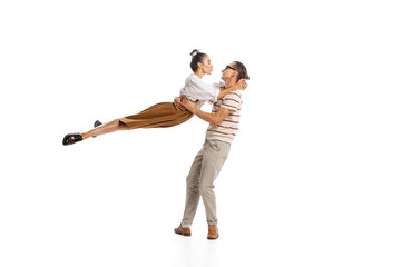 Portrait of stylish man and woman in retro outfit posing together isolated over white studio...