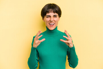 Young caucasian woman with a short hair cut isolated upset screaming with tense hands.