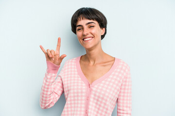 Young caucasian woman with a short hair cut isolated showing a horns gesture as a revolution concept.