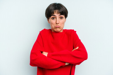 Young caucasian woman with a short hair cut isolated shrugs shoulders and open eyes confused.
