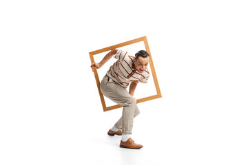 Portrait of stylish man appearing from picture frame isolated over white background. Retro style
