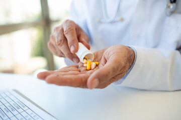 Hand of doctors holding many different pills. Photo of doctor prescribes pills and antibiotics. Medicine and treatment concept background.
