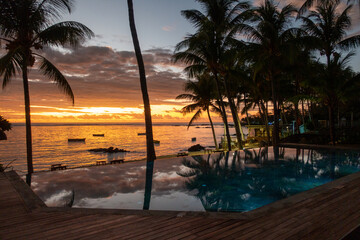 Sunrise with reflection at at hotel pool in Belle Mare, Mauritius