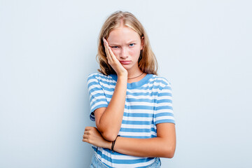 Caucasian teen girl isolated on blue background who is bored, fatigued and need a relax day.