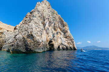 Blue Cave carved in the limestone by the Adriatic Sea, tourists sailing by boat to the grotto, Bisevo Island, Croatia