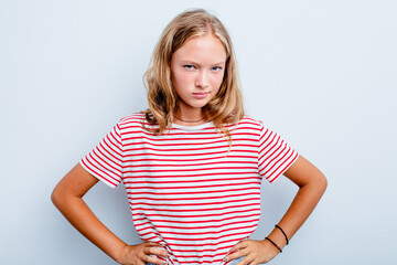 Caucasian teen girl isolated on blue background frowning face in displeasure, keeps arms folded.