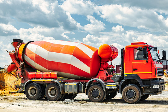 Concrete mixer truck in front of a concrete batching plant, cement factory. Loading concrete mixer truck. Close-up. Delivery of concrete to the construction site. Monolithic concrete works.