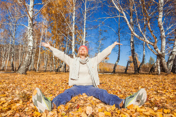 middle aged woman in the autumn weather in warm clothes and hats