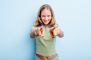 Caucasian teen girl isolated on blue background cheerful smiles pointing to front.