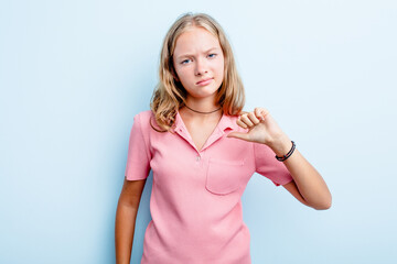 Caucasian teen girl isolated on blue background showing thumb down, disappointment concept.