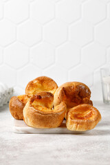 Yorkshire pudding on plate close up. English traditional food, dessert. Tile background