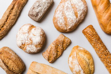 Homemade natural breads. Different kinds of fresh bread as background, top view with copy space